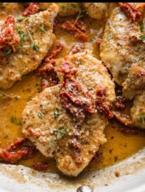 This bright Chicken in Sun Dried Tomato Cream Sauce has the bold flavors of garlic, Parmesan, oregano, and thyme all packed into a cozy dish. All done in one skillet and 30 minutes, it's delicious for family dinner, elegant enough for guests.