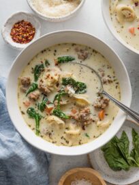 This Sausage Tortellini Soup is deliciously creamy yet not too heavy, with tender carrots and spinach, cheese tortellini, and Italian sausage all simmered in a flavorful broth. Best of all, you just need one pot and about 30 minutes to get this served up from start to finish.