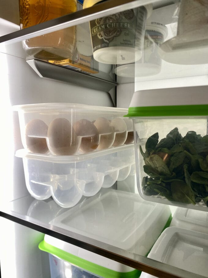 Real life photo of clear egg containers in a fridge.