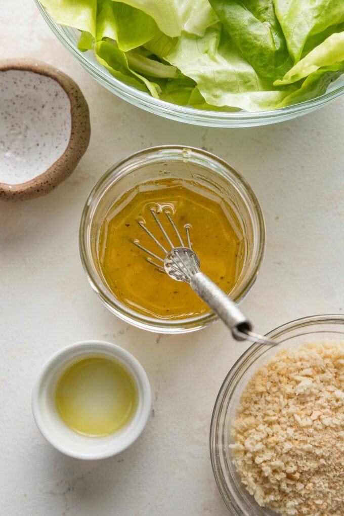 Close up of a very simple apple cider vinaigrette whisked together in a small jar.
