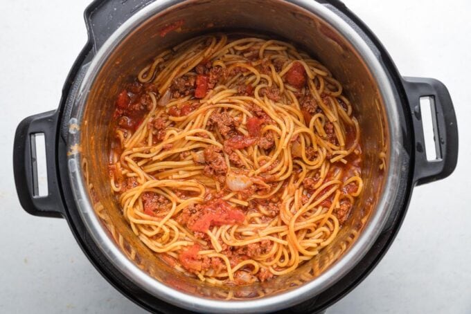 Instant Pot full of spaghetti with meat sauce, fully cooked and ready to serve.