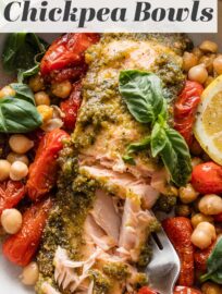 Pesto Salmon Bowls with Chickpeas are fresh, vibrant, and packed with flavor despite the simple ingredient list and minimal prep. Tender salmon is slathered in pesto and roasted alongside plump cherry tomatoes and creamy chickpeas for the most satisfying lunch or dinner. Easy to meal prep, as well.