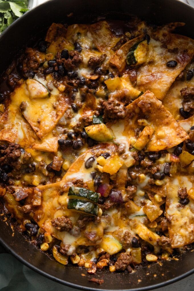 Beef enchilada skillet just pulled out of the oven, with gooey melted cheese on top.
