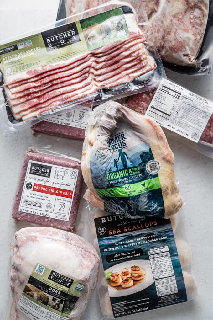Flatlay photo of ButcherBox products spread on a kitchen counter to accompany a comprehensive ButcherBox review.