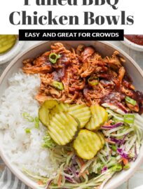 Easy and flavorful, these pulled BBQ chicken bowls make a flexible, build-your-own dinner that can please everyone. Tender, slow-cooked BBQ chicken, healthy homemade slaw, green onions, and crisp pickles are an irresistible combination!