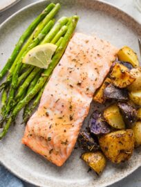 Simple to make, well-balanced, and full of flavor, this recipe for sheet pan salmon with potatoes proves that prepping real food can be quick and hassle-free. Crispy potatoes, tender asparagus, and glazed salmon filets all roast on one pan for a high-satisfaction, low-effort dinner.