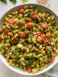 This Pesto Pasta Salad is a fresh, flavorful twist on a classic! Tossed with juicy cherry tomatoes, creamy mozzarella balls, and crunchy toasted pine nuts, it’s the perfect make-ahead side dish for cookouts, potlucks, or easy weeknight dinners.