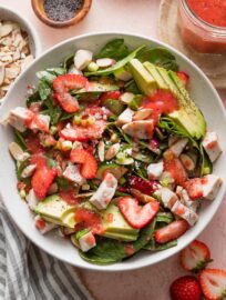 A beautiful, flavorful Strawberry Spinach Salad with Chicken is a vibrant lunch or dinner-worthy bowl, packed with dark leafy greens, juicy berries, crunchy almonds, and creamy goat cheese. We especially love pairing it with an easy homemade strawberry vinaigrette.