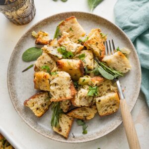Small plate full of cozy bread stuffing with herbs.