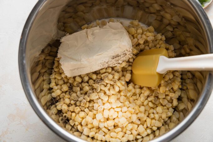 Ingredients for creamed corn together in the bowl of an Instant Pot.