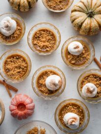 Overhead view of mini pumpkin custards laid out on a counter.