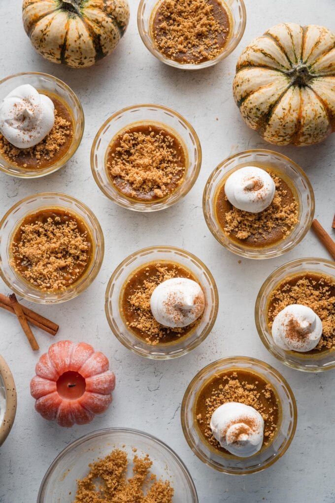 Overhead view of mini pumpkin custards laid out on a counter.