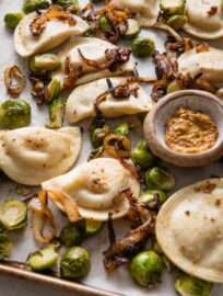 This recipe for sheet pan pierogies with Brussels sprouts and richly caramelized onions is the easiest way to upgrade the humble pillows of dough and cheese. Simple seasonings, crisp-tender veggies, and the simplicity of oven roasting are just what weeknights need.