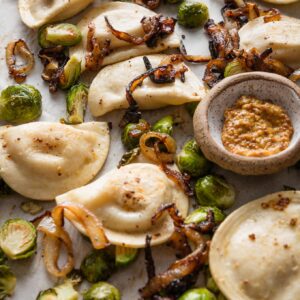 This recipe for sheet pan pierogies with Brussels sprouts and richly caramelized onions is the easiest way to upgrade the humble pillows of dough and cheese. Simple seasonings, crisp-tender veggies, and the simplicity of oven roasting are just what weeknights need.