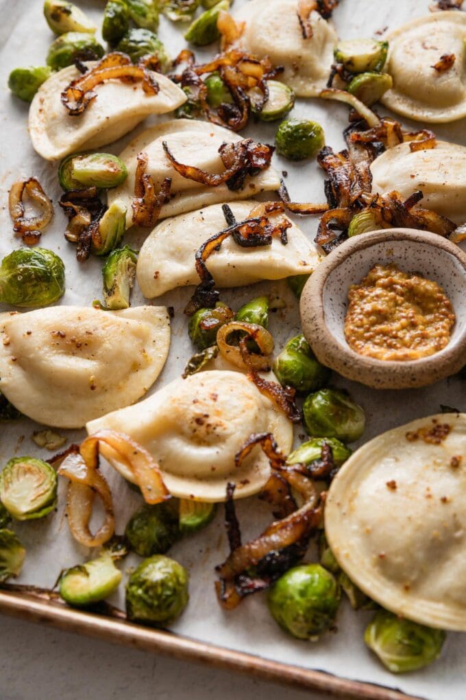 This recipe for sheet pan pierogies with Brussels sprouts and richly caramelized onions is the easiest way to upgrade the humble pillows of dough and cheese. Simple seasonings, crisp-tender veggies, and the simplicity of oven roasting are just what weeknights need.