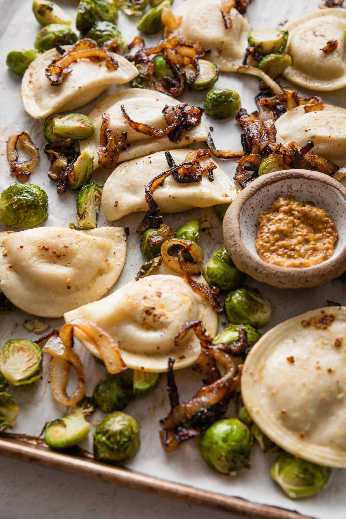 This recipe for sheet pan pierogies with Brussels sprouts and richly caramelized onions is the easiest way to upgrade the humble pillows of dough and cheese. Simple seasonings, crisp-tender veggies, and the simplicity of oven roasting are just what weeknights need.