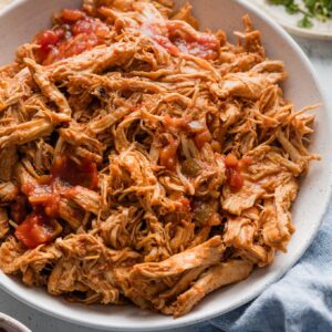 Bowl full of shredded salsa chicken made in the Instant Pot.
