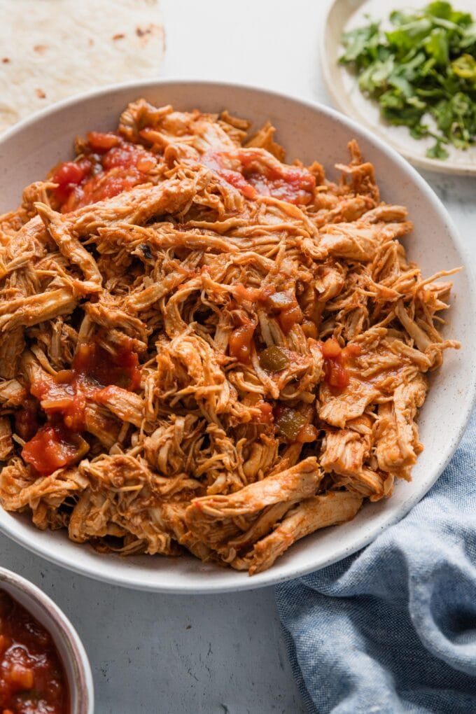 Bowl full of shredded salsa chicken made in the Instant Pot.