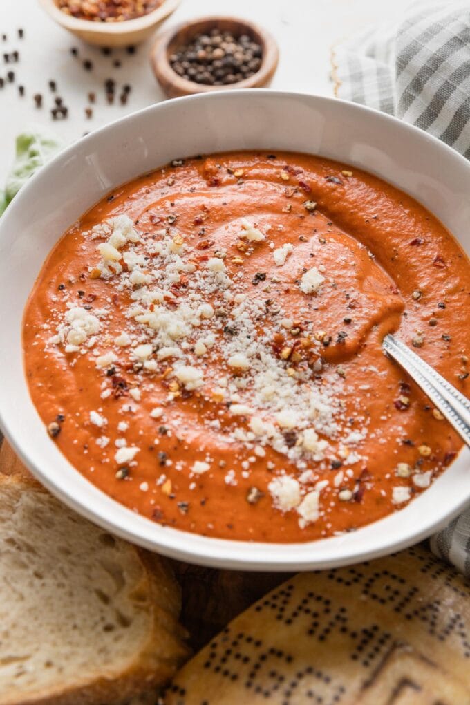 Angled view of a bowl of creamy tomato butternut soup.