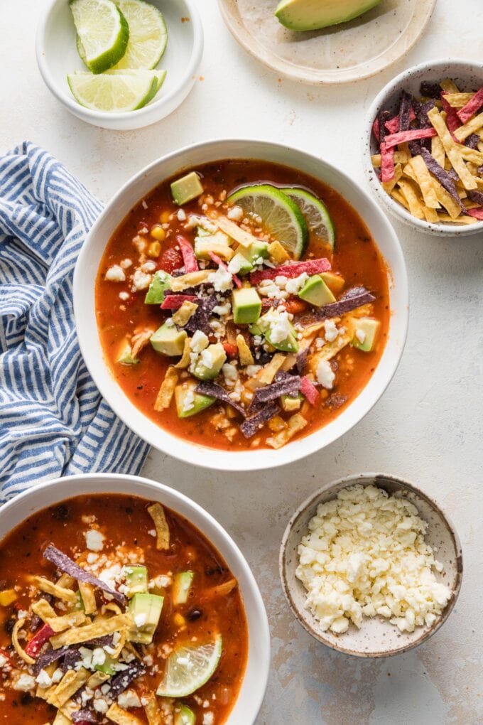 Countertop set with bowls of chipotle chicken tortilla soup.