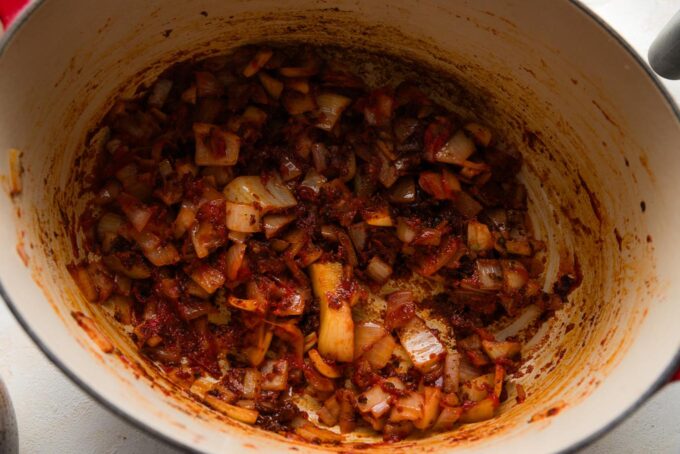 Base of a tortilla soup simmering in an oval Dutch oven.