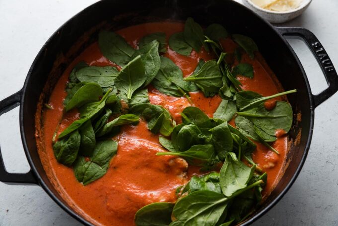 Chicken breasts and baby spinach nestled into homemade tomato cream sauce.