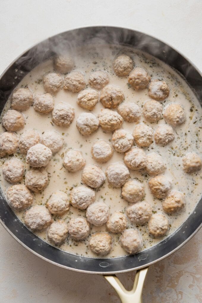 Frozen meatballs stirred into a skillet with a creamy beef broth-based sauce.