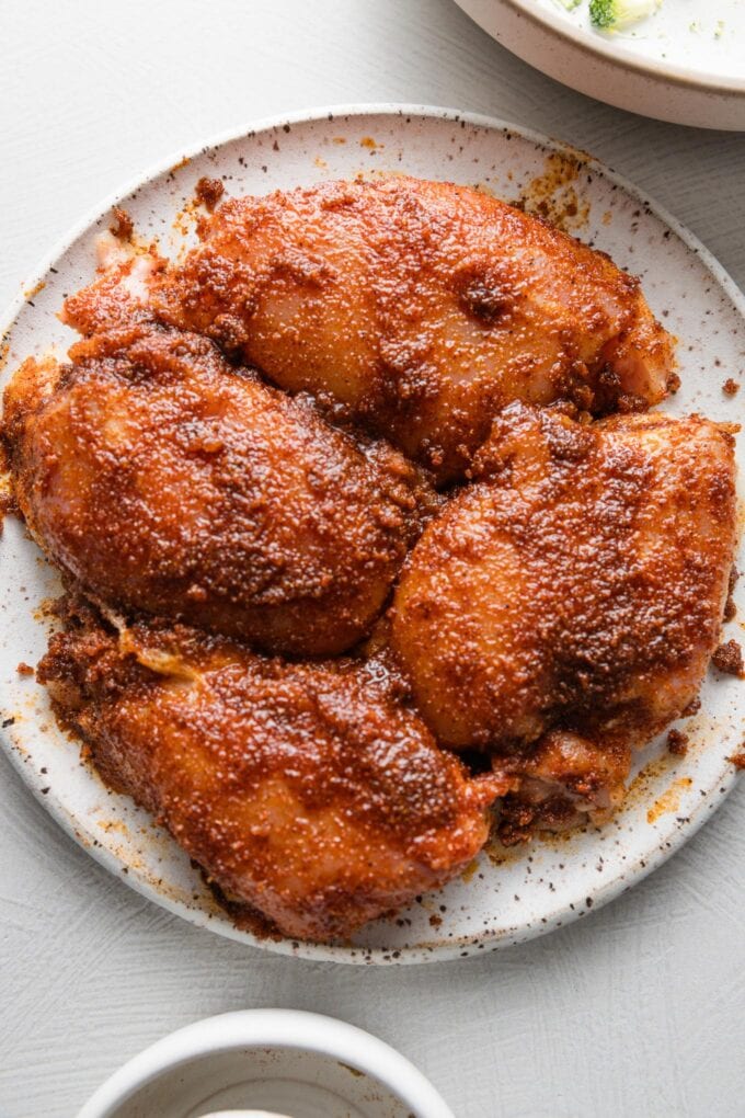 Chicken thighs with a spice rub, ready to cook.