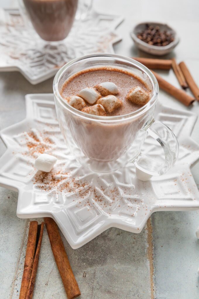 Clear double-walled mug of homemade hot cocoa served with marshmallows.