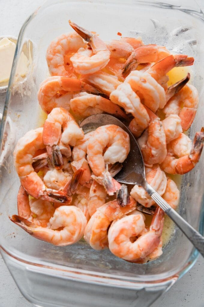 Cooked shrimp in a baking dish.