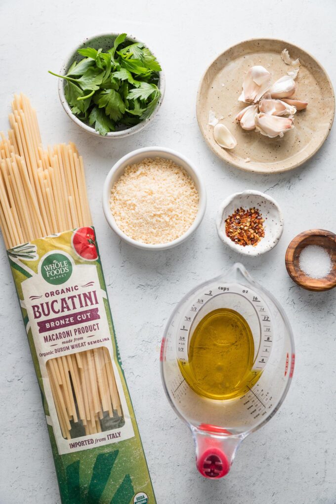 Flat lay image of the ingredients for a great garlic and oil pasta made with bucatini.