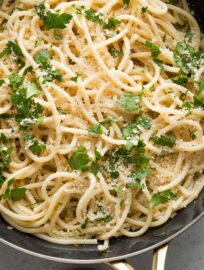 Close up of spaghetti aglio e olio in a large skillet.