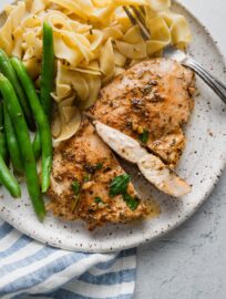 Close up of a garlic butter chicken breast sliced open to show the tender, juicy, interior.
