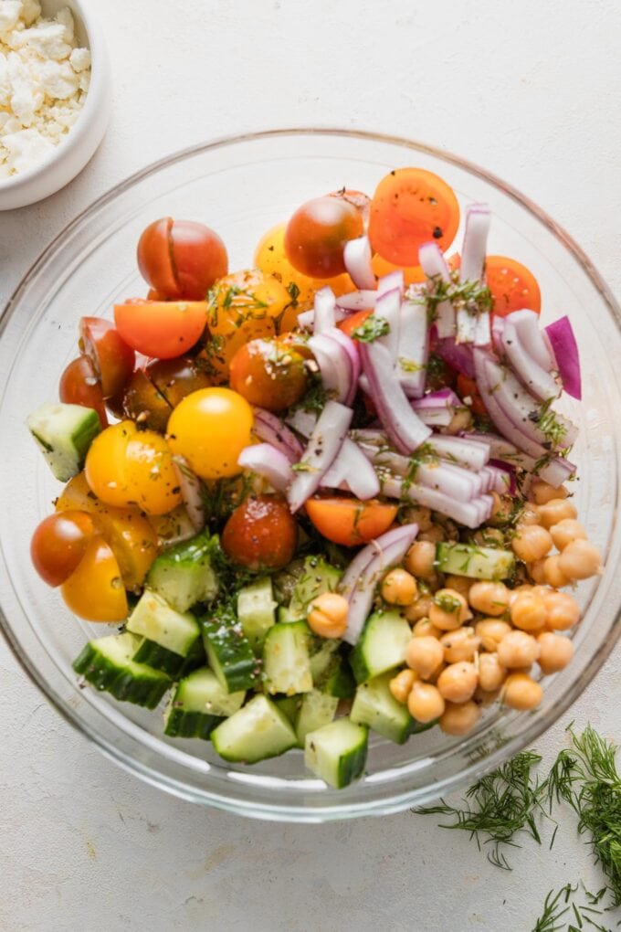 Large glass prep bowl full of chickpeas and vegetables.