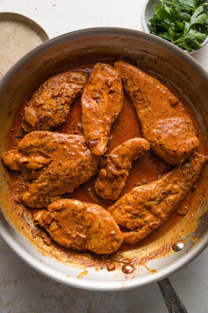 Chicken breasts nestled into a paprika cream sauce with onions and garlic.