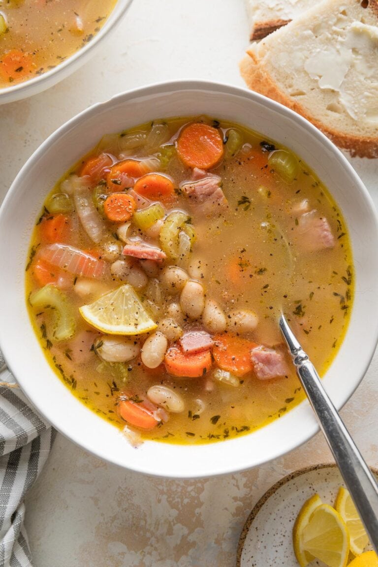 Bowl of ham and white bean soup with lots of carrots and other veggies.
