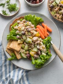 Small plate of Mediterranean tuna salad with carrots and Triscuits.