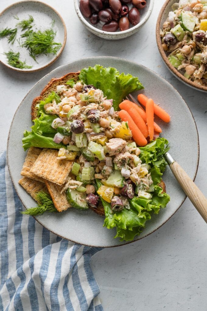 Small plate of Mediterranean tuna salad with carrots and Triscuits.