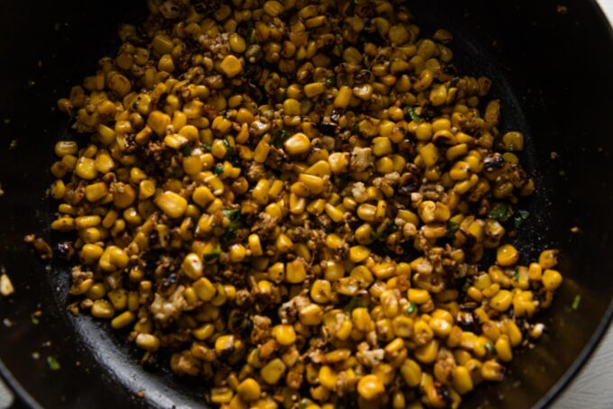 Corn blackened in a cast iron skillet.
