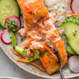 Close up of flaky salmon filet roasted with Thai sweet chili sauce.