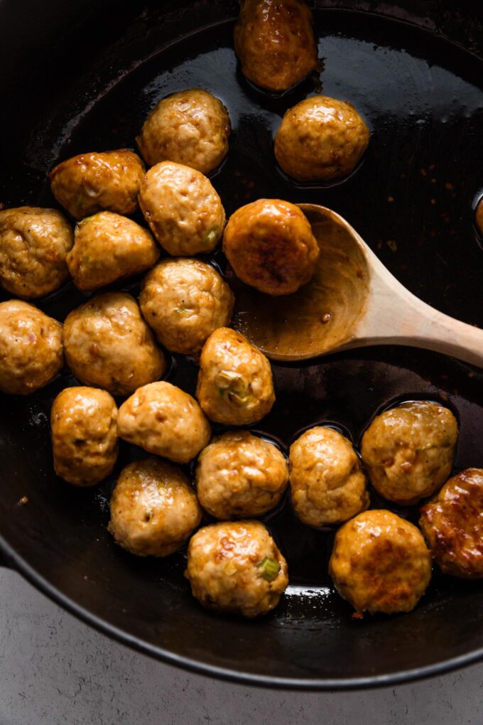 Baked chicken meatballs tossed in a skillet with a quick homemade glaze.