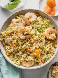Lunch salad with poached shrimp, pearl couscous, fresh basil and basil dressing, slivered almonds, dried apricots, and shallots.