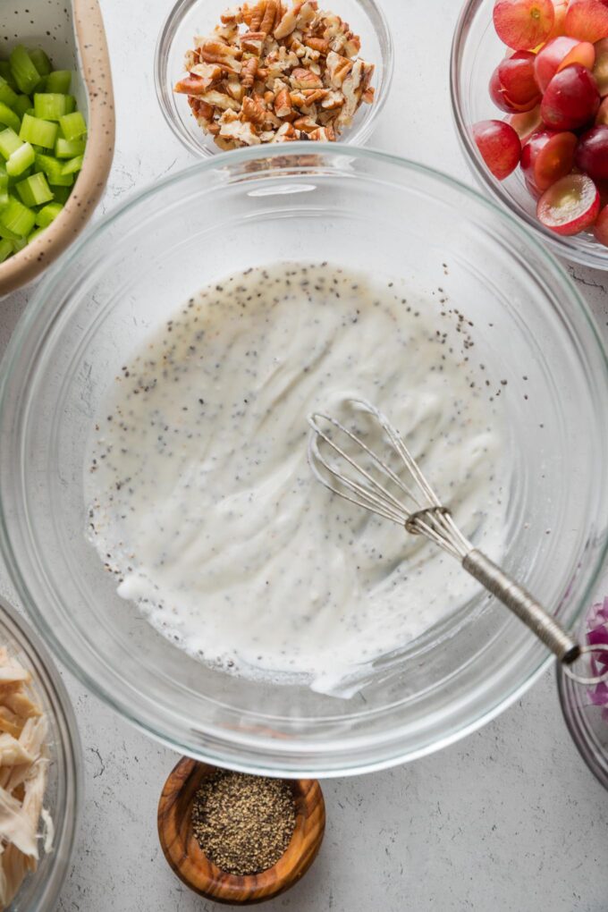 Greek yogurt-based dressing for chicken salad mixed together in a large glass prep bowl.