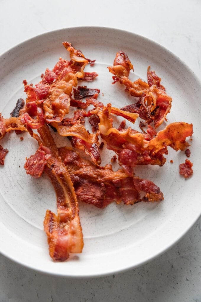 Crisped bacon on a plate.