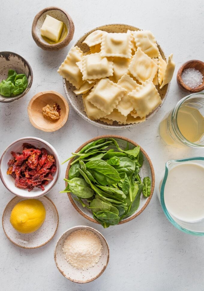 Flat lay image of the ingredients needed for a simple, one pan Tuscan ravioli recipe.