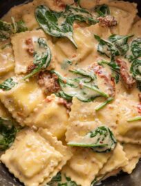 Close up of a 20 minute Tuscan ravioli recipe in a skillet.