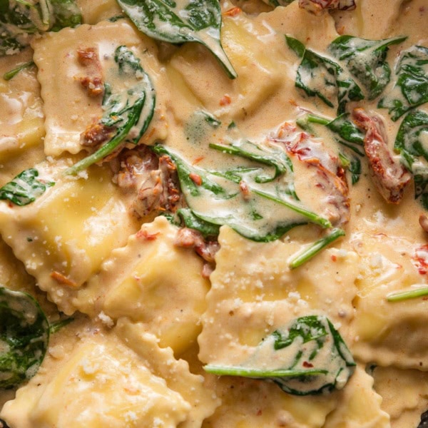 Close up of a 20 minute Tuscan ravioli recipe in a skillet.