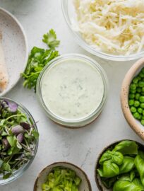 Homemade green goddess salad dressing with Greek yogurt, herbs, and jalapeño is so easy to make and way more fresh and vibrant than even the best store-bought. Of course it's the perfect finishing touch for a gigantic green goddess salad; it's also delicious as a dipping sauce for fresh veggies or casual chicken wraps. Creamy, herbacious, and preservative-free.