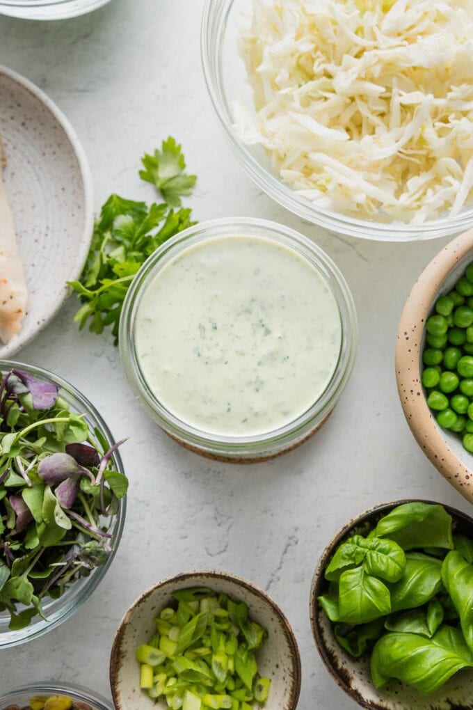 Homemade green goddess salad dressing with Greek yogurt, herbs, and jalapeño is so easy to make and way more fresh and vibrant than even the best store-bought. Of course it's the perfect finishing touch for a gigantic green goddess salad; it's also delicious as a dipping sauce for fresh veggies or casual chicken wraps. Creamy, herbacious, and preservative-free.
