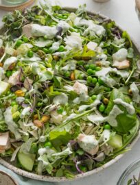 Green goddess salad in a large speckled ceramic bowl.